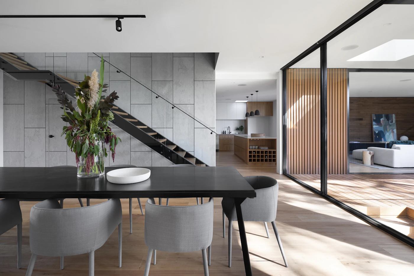 Bright contemporary interior with a sculptural stair and natural materials